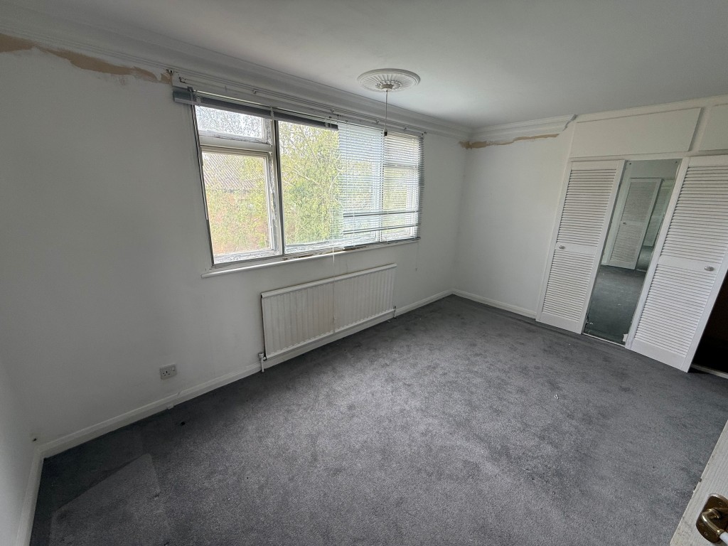 Lot: 136 - FOUR-BEDROOM DETACHED HOUSE FOR REPAIR AND MODERNISATION - Bedroom one with built in wardrobe and window
